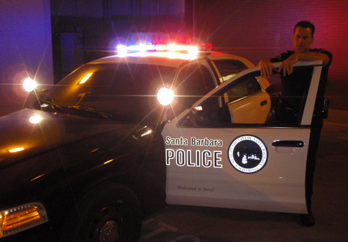 Santa Barbara police officer at his vehicle