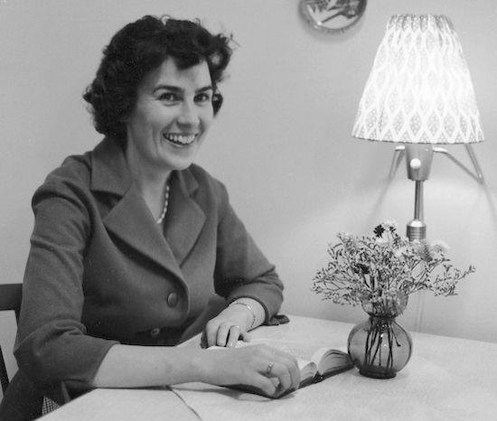 Mom is reading at the kitchen table in Stureby, Sweden