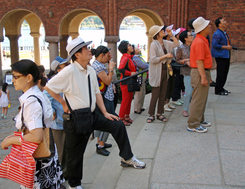 Japanese tourists have a look at Stockholm City Hall, Sweden